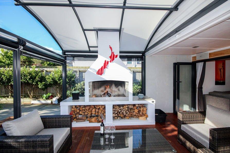 awning-nz outdoor room with fireplace covered by a fresco canopy