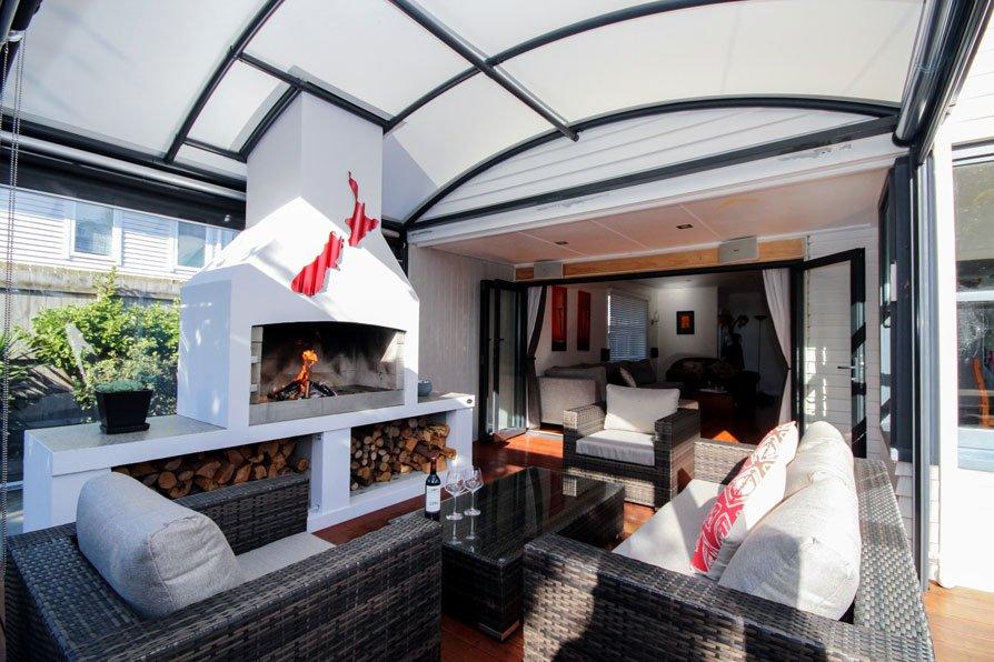 awning-nz-2 outdoor room with fireplace covered by a fresco canopy