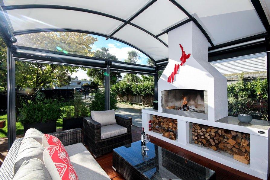 outdoor-fire-canopy-room outdoor room with fireplace covered by a fresco canopy