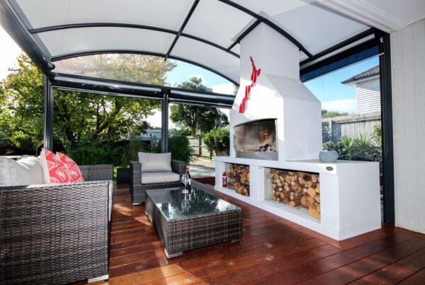outdoor room with fireplace covered by a fresco canopy
